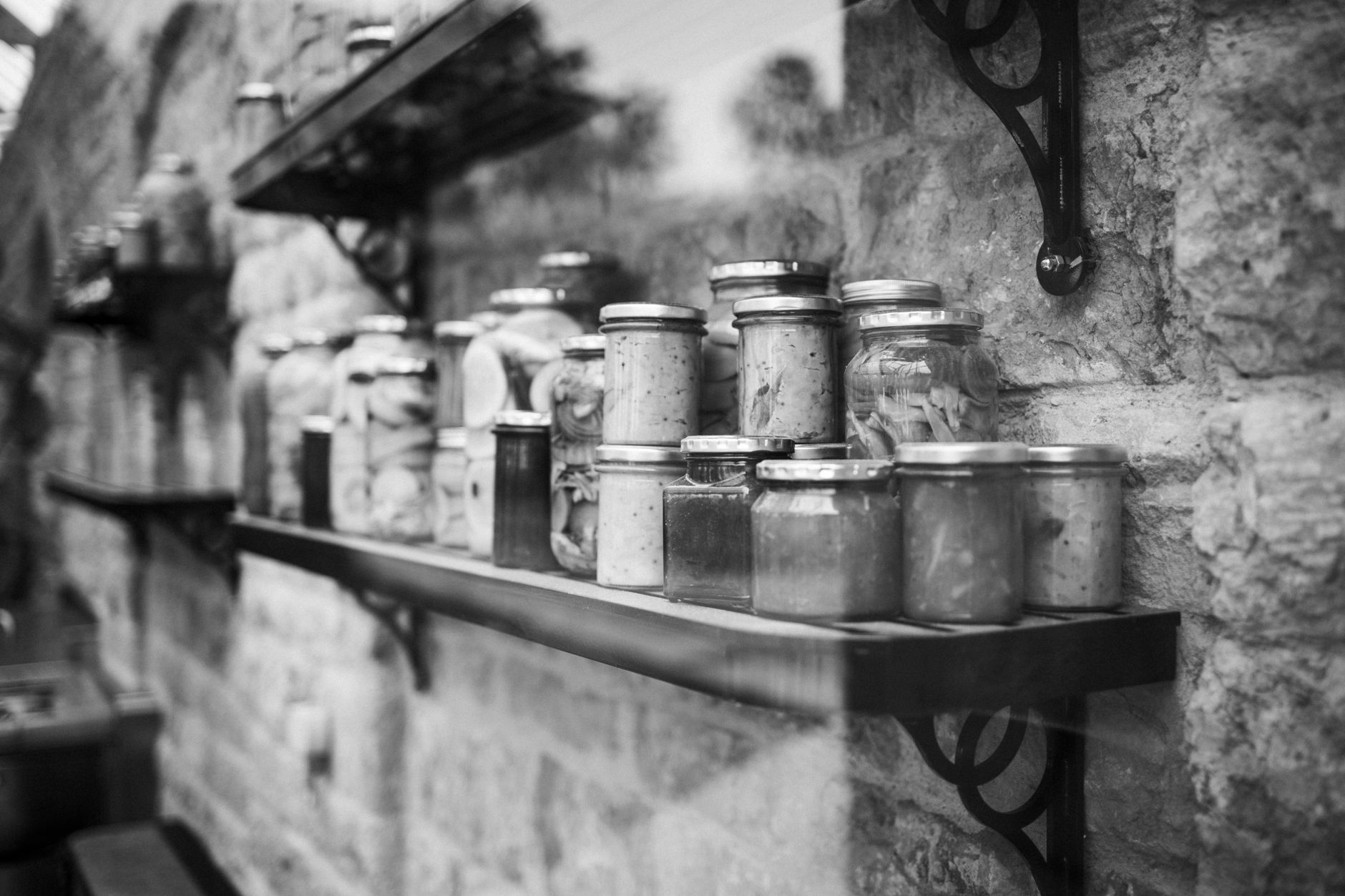 Shelves stocked with food at a community pantry UK, warm natural light