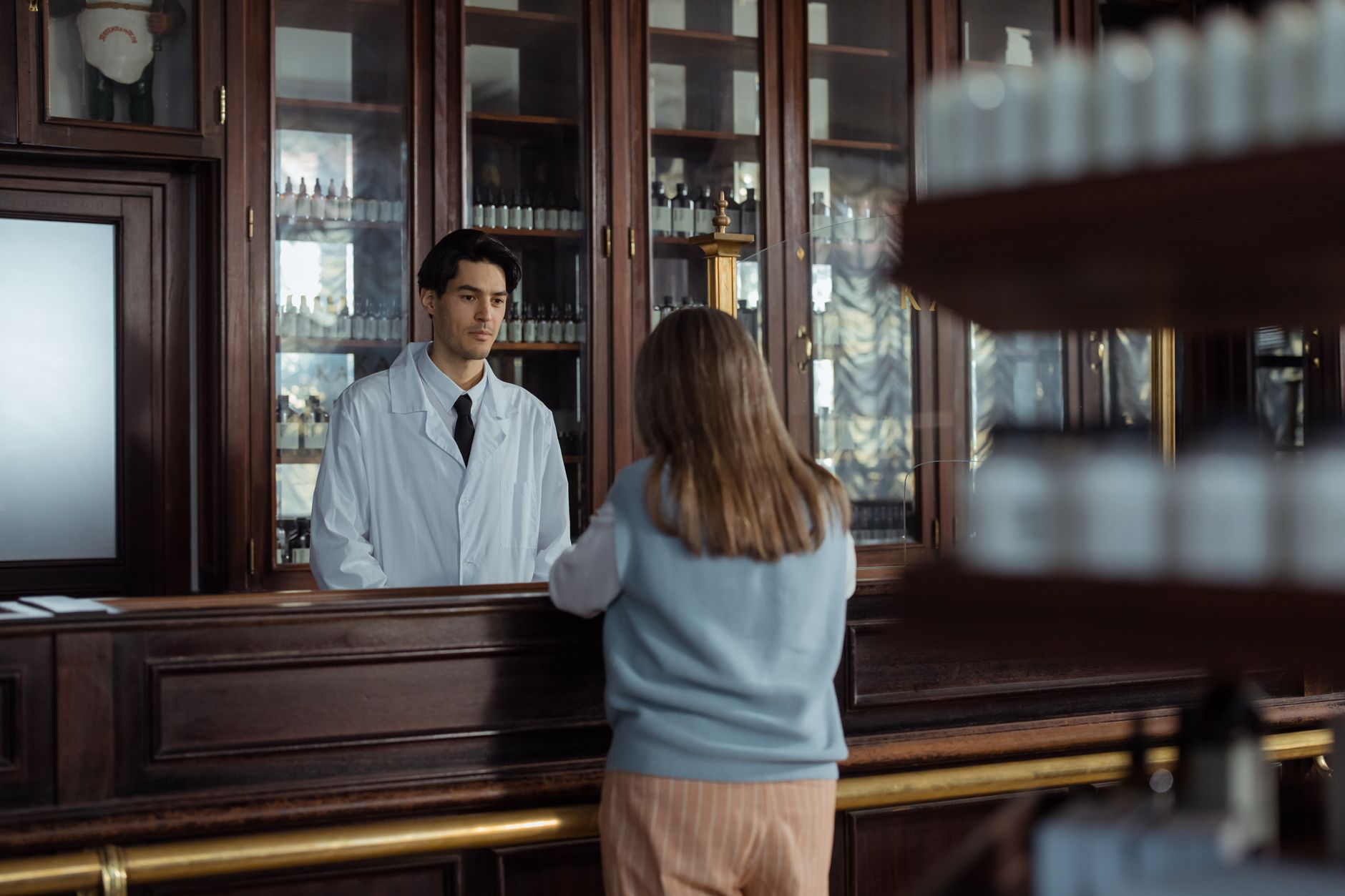 Pharmacy First service as part of NHS primary care 2026 — pharmacist advising a patient